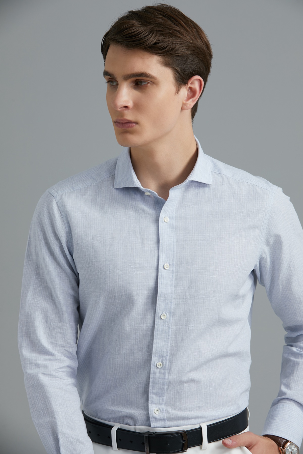 Male model wearing a white dress shirt, dark tie and trousers